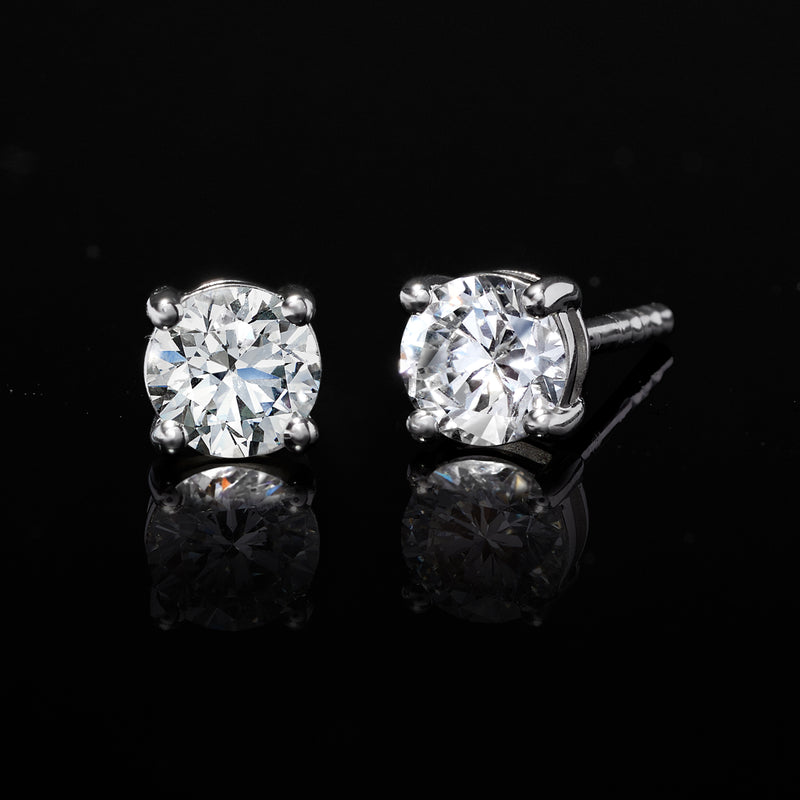 Sterling silver diamond stud earrings with bright round lab-grown stones, four-prong backs