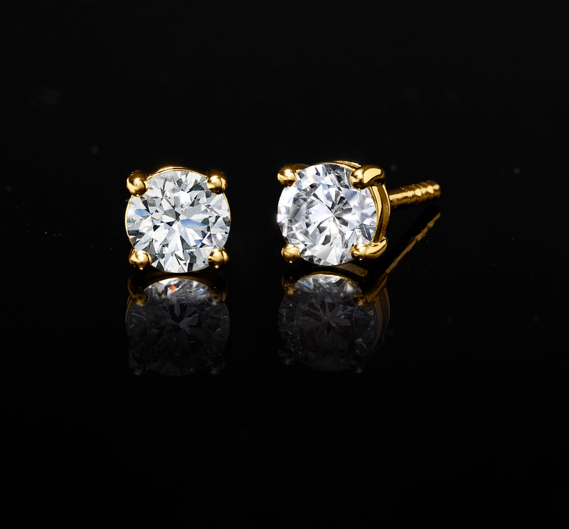 Round diamond stud earrings with gold four-prong settings