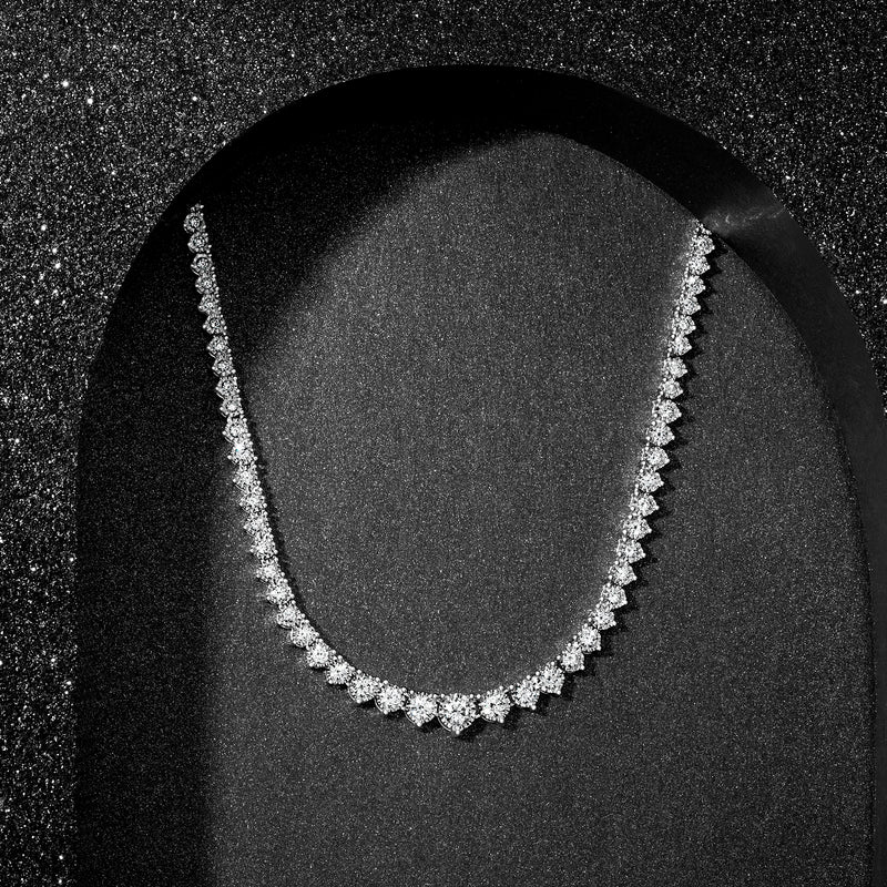 Graduated diamond tennis necklace; white stones with sterling silver setting, angled view