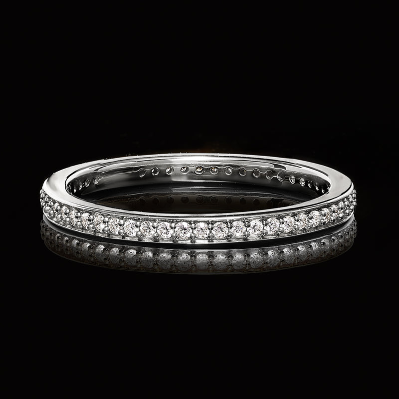 Sterling silver eternity band with round lab-grown diamonds, angled side view.
