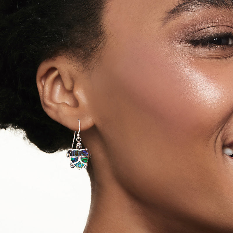 Sterling silver turtle drop earrings with abalone shell inlay on ear, hook style