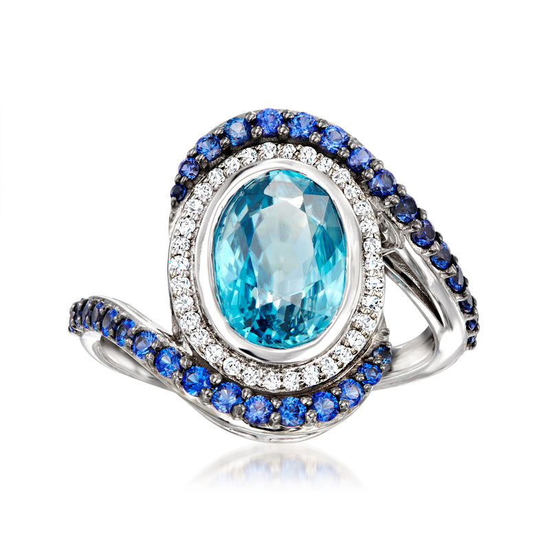 Oval blue zircon center ring with diamond halo and blue gemstone pave in white gold