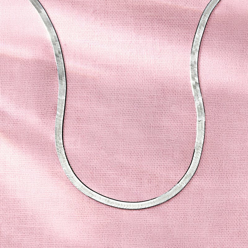 Close-up of sterling silver herringbone necklace chain links