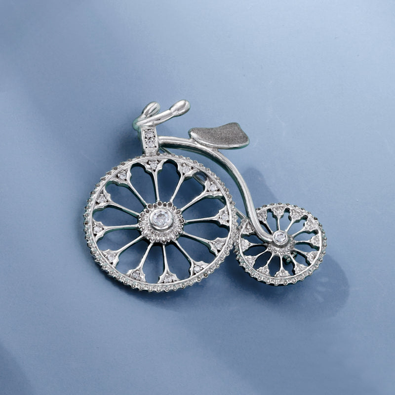 Diamond bicycle pin with openwork filigree wheels and small round stones, white gold.