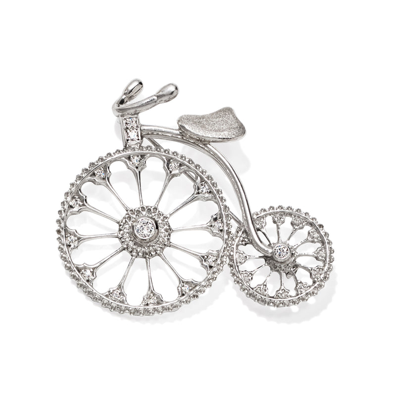 Diamond bicycle pin with detailed openwork wheels and a central round stone, white gold.