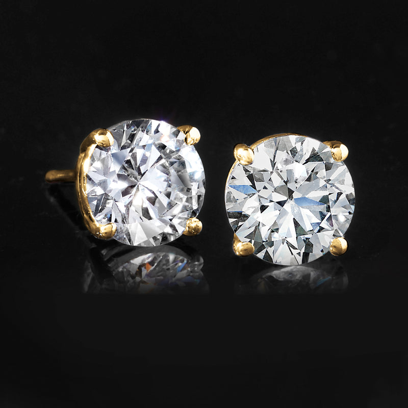 Yellow gold round diamond stud earrings with prong setting, close-up