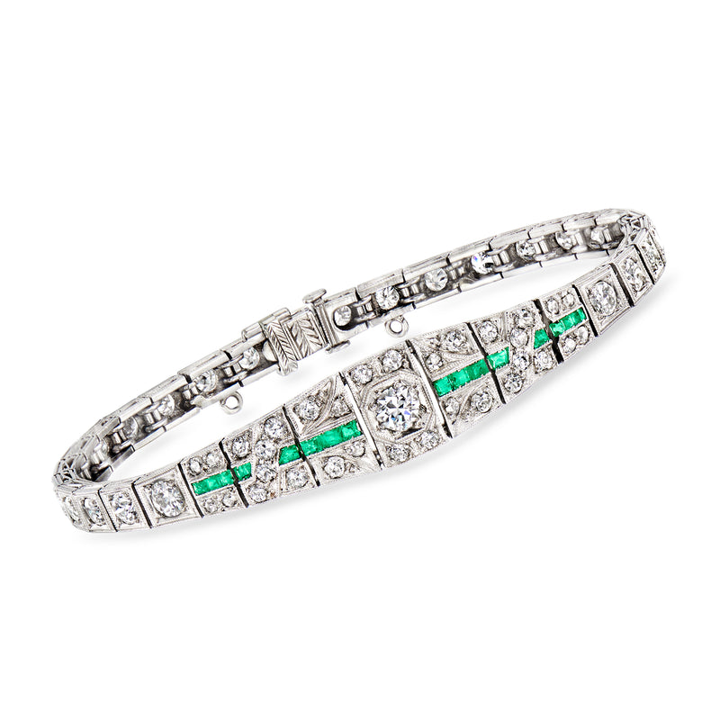Platinum diamond and emerald tennis bracelet with geometric panel setting, hinged clasp.