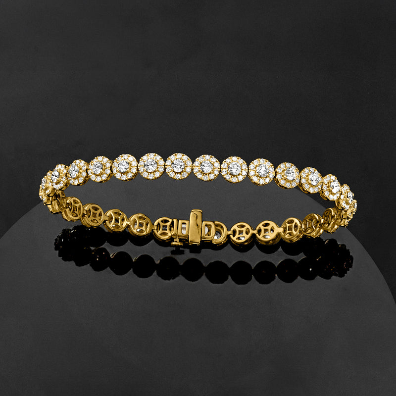 Yellow gold diamond halo tennis bracelet with round stones and hinge-style clasp, angled