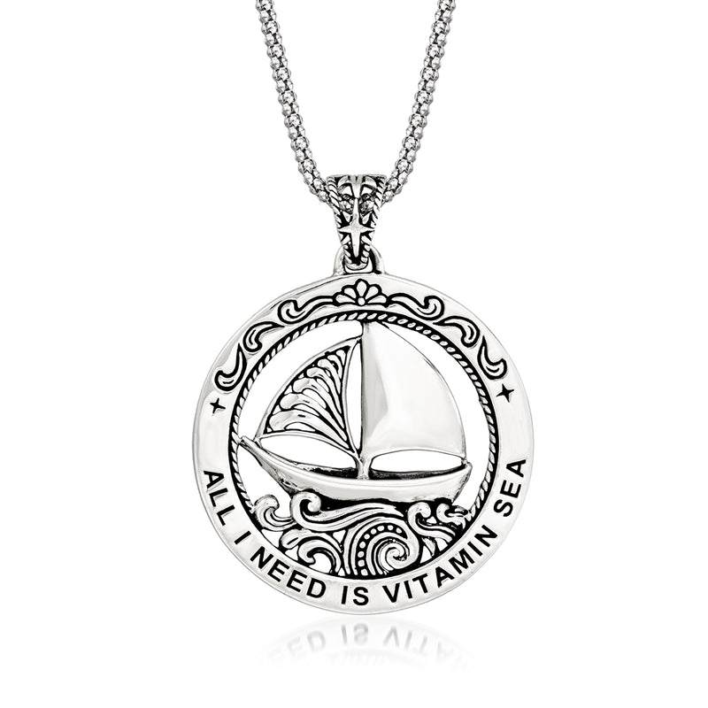 Round sterling silver pendant necklace with sailboat medallion, 'All I Need Is Vitamin Sea'.