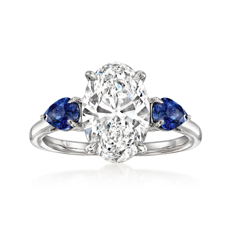 14kt white gold ring with round lab-grown diamond center and blue sapphire side stones