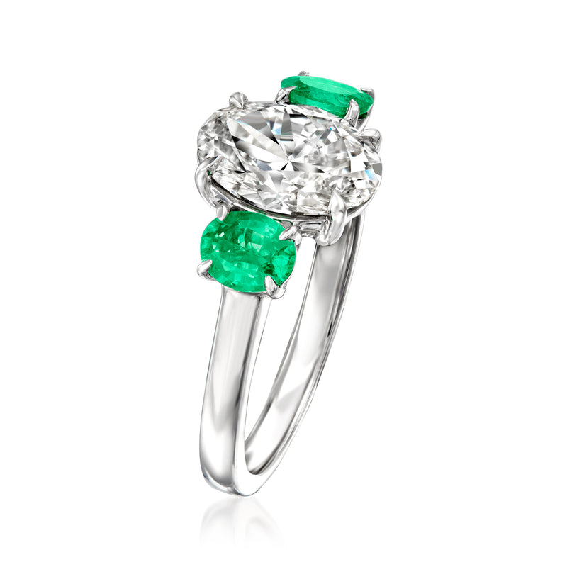14kt white gold diamond ring angled view with round center diamond and green emeralds