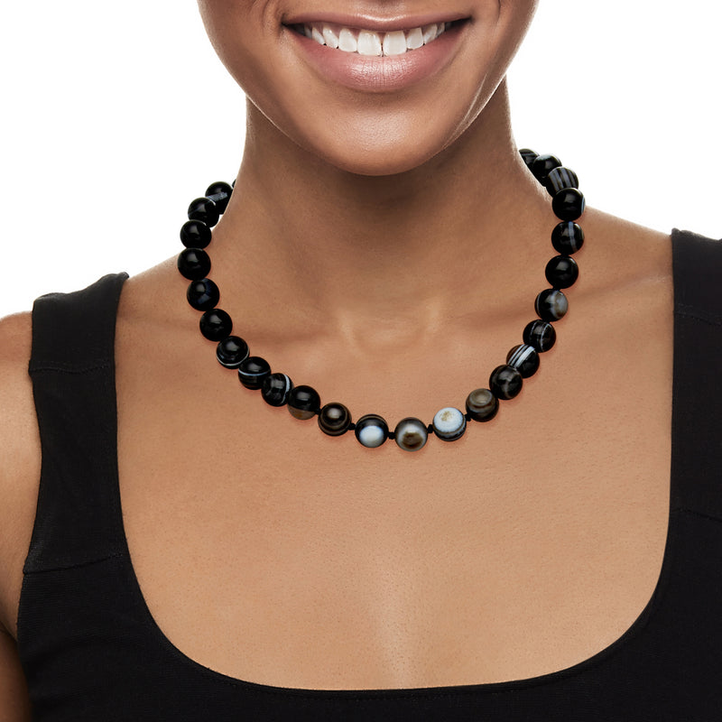Black agate bead necklace on model’s neck, with blue-gray and white accent beads