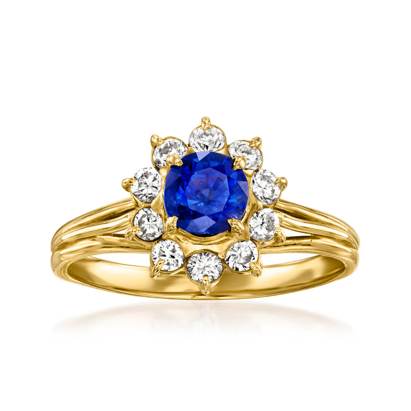18kt yellow gold ring with blue sapphire center and round diamond halo