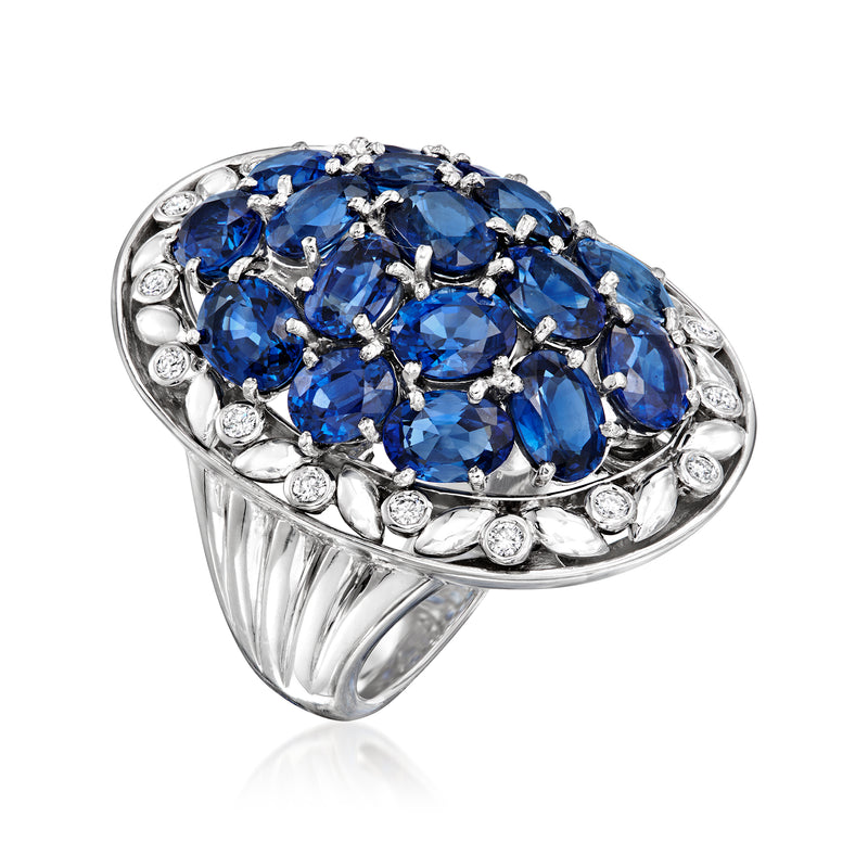 White metal ring with raised blue sapphire oval cluster and round diamond accents