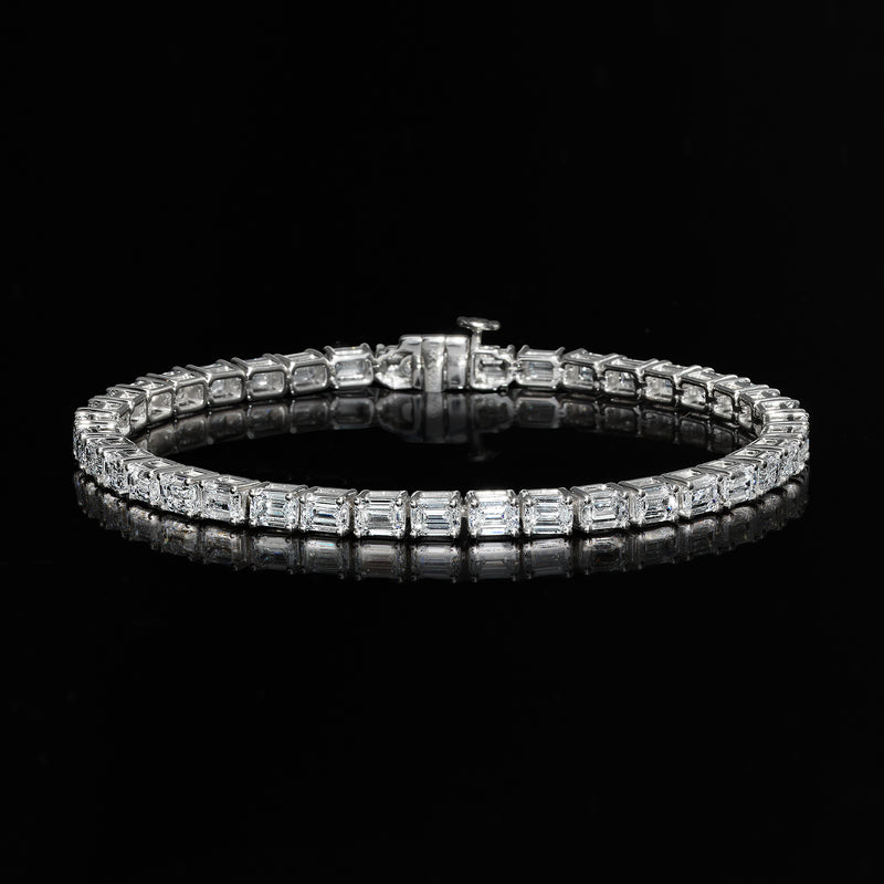 Diamond tennis bracelet with emerald-cut stones, linked rows in white gold