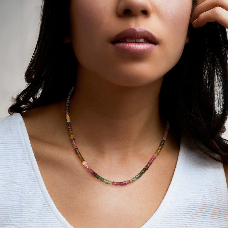 Multicolored tourmaline bead necklace on model, round beads in pink green and yellow