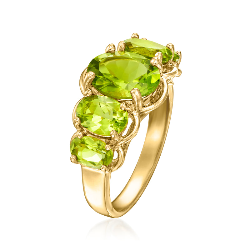 Peridot five-stone ring showing large oval green center stone with two side stones
