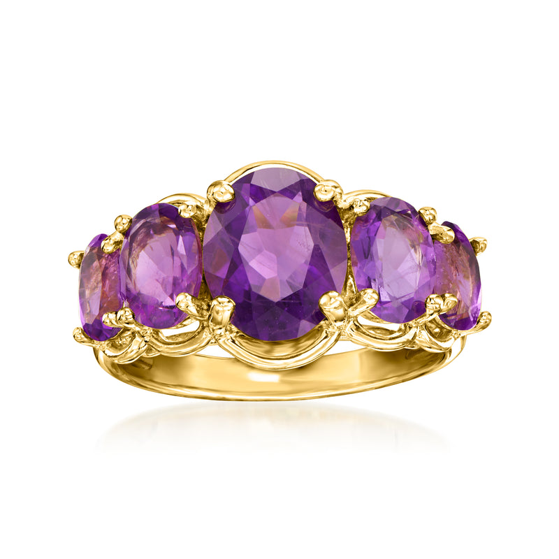Gold over sterling five-stone amethyst ring with three purple oval stones and scalloped prongs