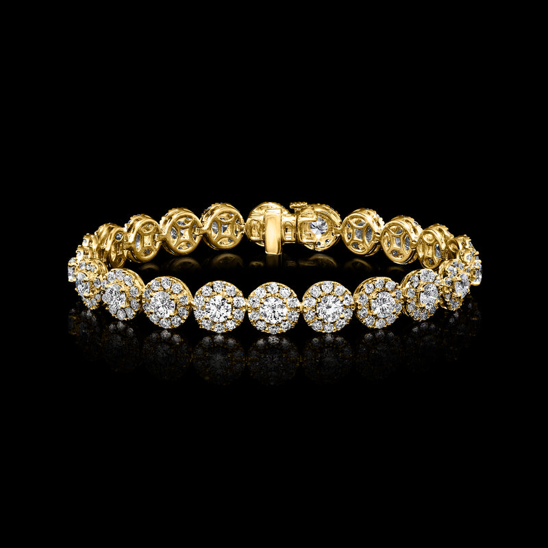 Yellow gold diamond halo bracelet with round brilliant stones across a flexible band