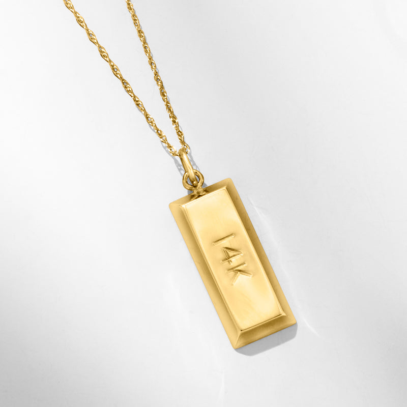 Yellow gold bar pendant with 14k engraving, hanging on chain