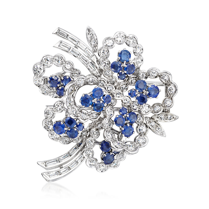 Floral sapphire and diamond pin with blue center stones in 18k white gold prongs