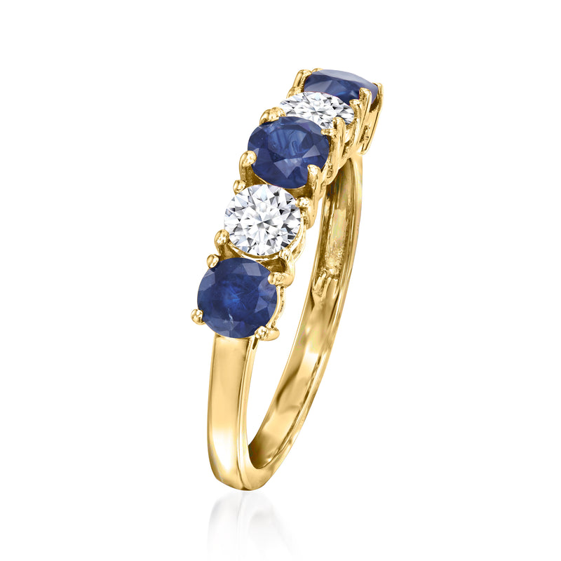 Yellow gold ring side view with blue sapphires and round diamond accents in prongs