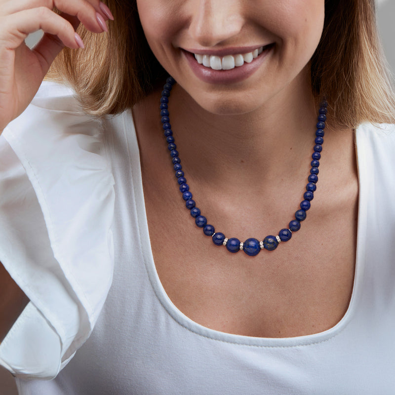 Lapis bead necklace with blue beads, worn at the collarbone with silver spacers