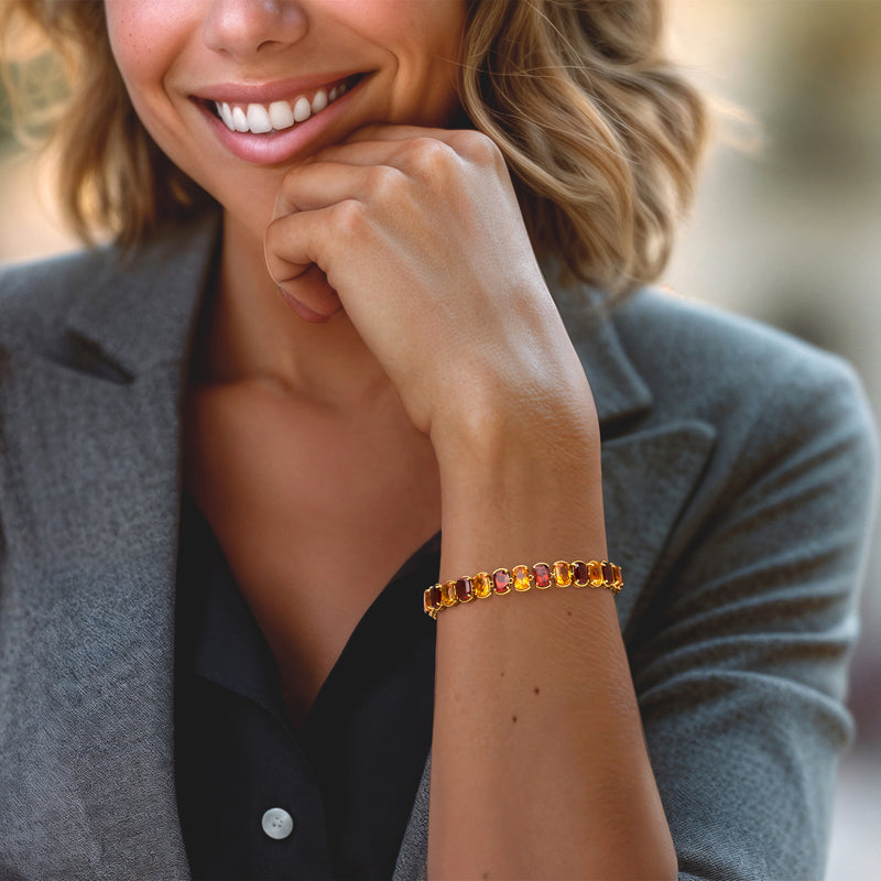 Garnet and citrine bracelet in 18kt gold over sterling on wrist, clasp visible