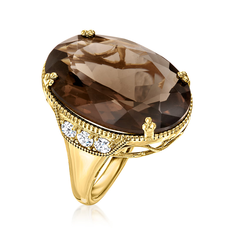 Gold-tone ring with oval smoky quartz top and white zircon row across the band.