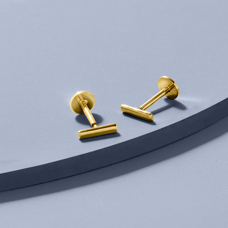Yellow gold bar stud earrings with flat backs and posts, pictured as a pair.