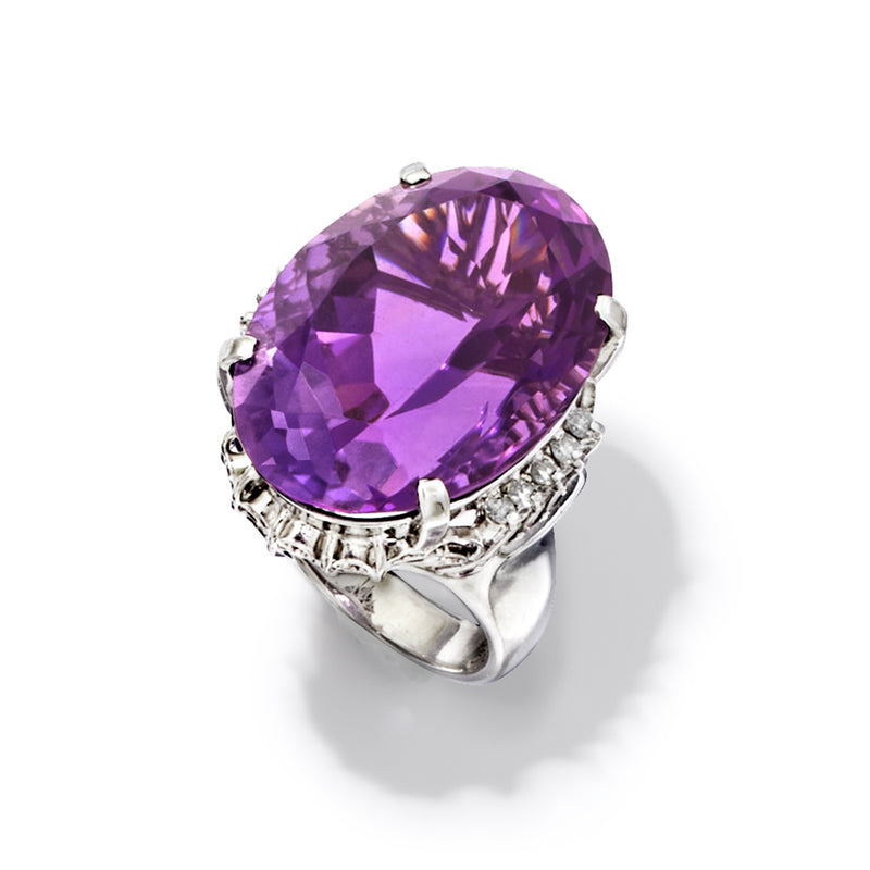 Oval amethyst ring in platinum with prong-set stone and jeweled diamond surround