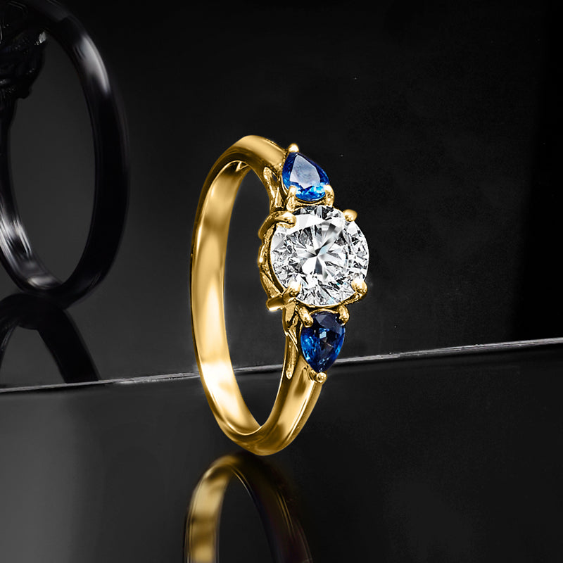 14kt yellow gold ring with round diamond and blue sapphires in prong setting
