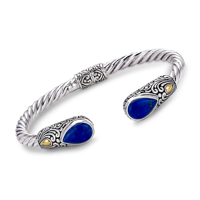 Sterling silver cuff bracelet with blue cabochon stones and yellow gold accents