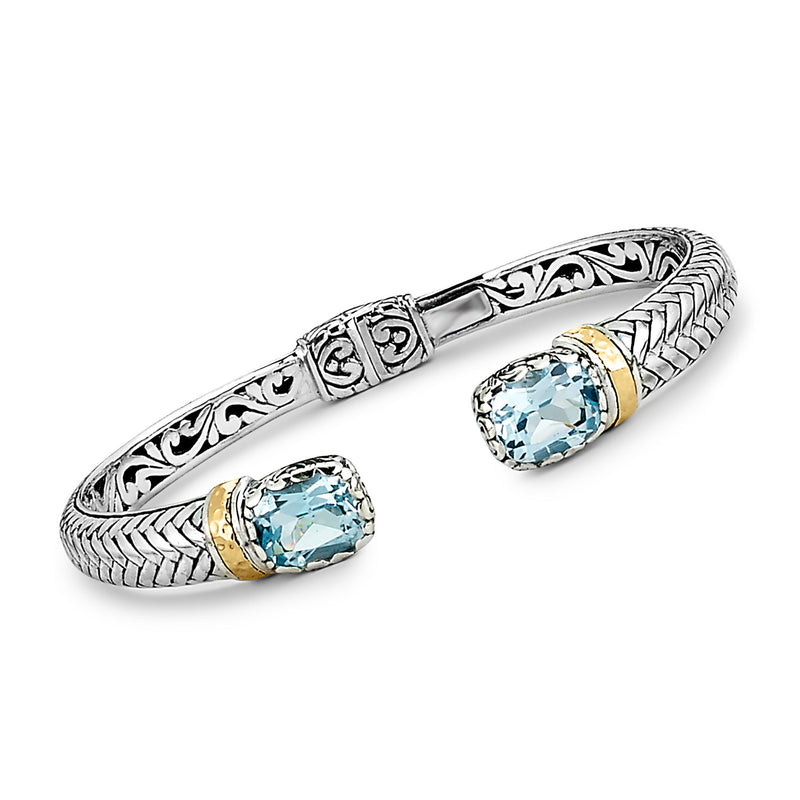 Sterling silver Bali cuff with two blue topaz stones and 18kt yellow-gold settings