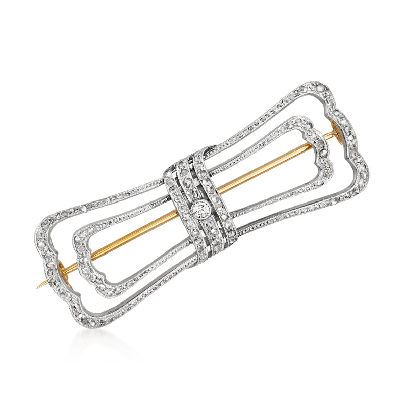 Platinum diamond bow pin with engraved border and yellow gold accents