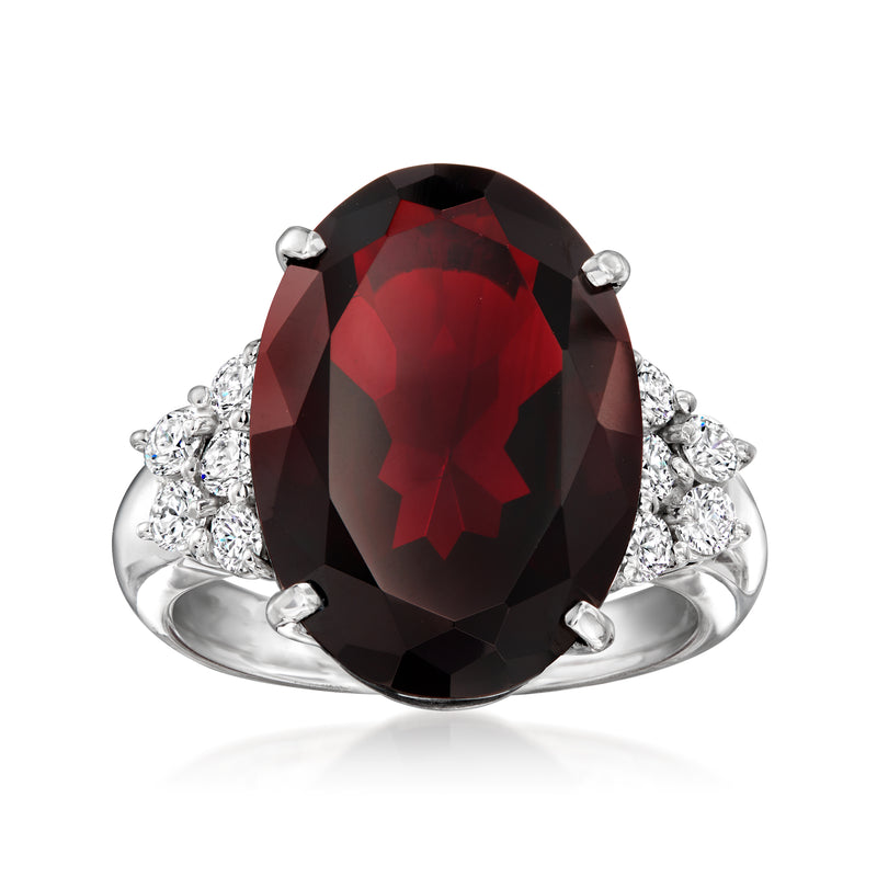 Platinum ring with large oval garnet center and surrounding diamond accents