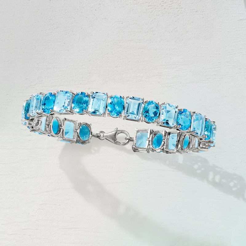 Sterling silver tennis bracelet with sky blue topaz baguette stones and box clasp