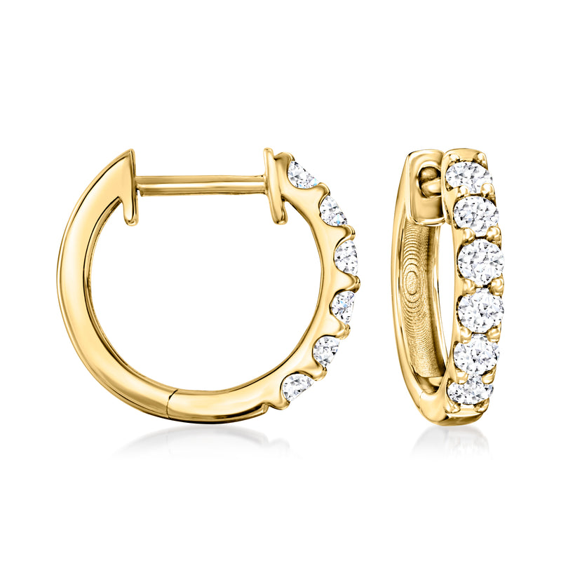Gold huggie hoop earrings with small round diamond accents along the front