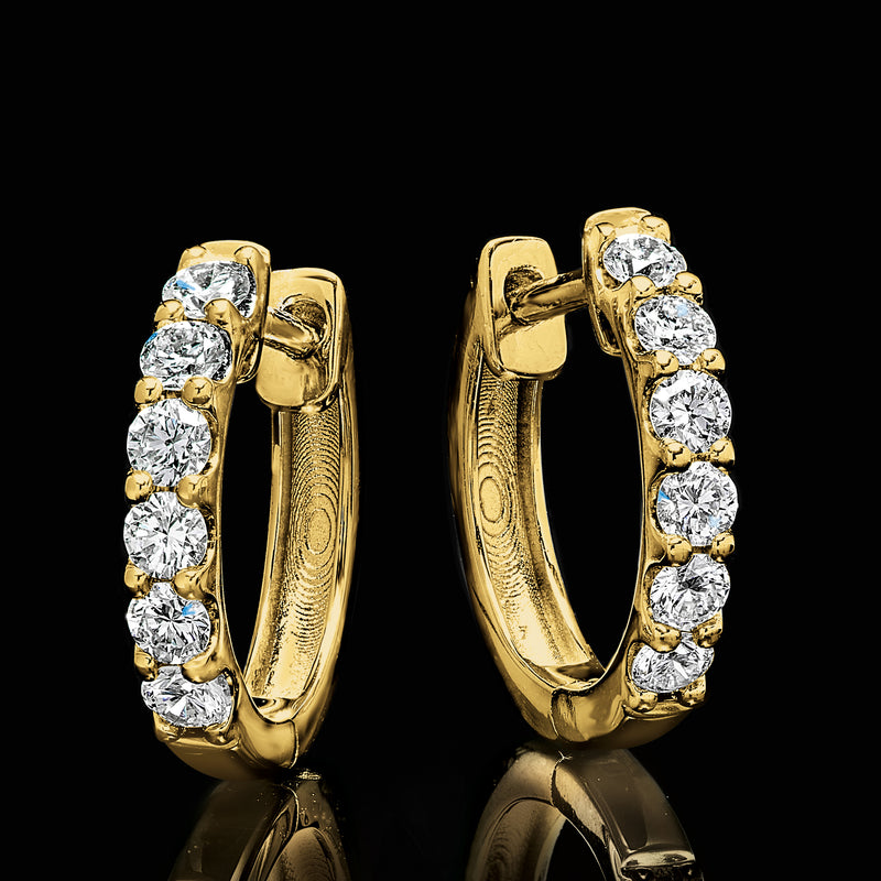 Gold huggie hoop earrings with round diamond clusters on curved sides, side view