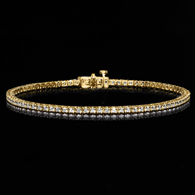 Gold tennis bracelet with sparkle row of round stones and box clasp