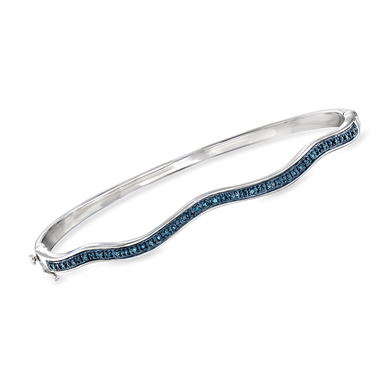 Sterling silver bangle bracelet with wavy blue diamond row along the cuff