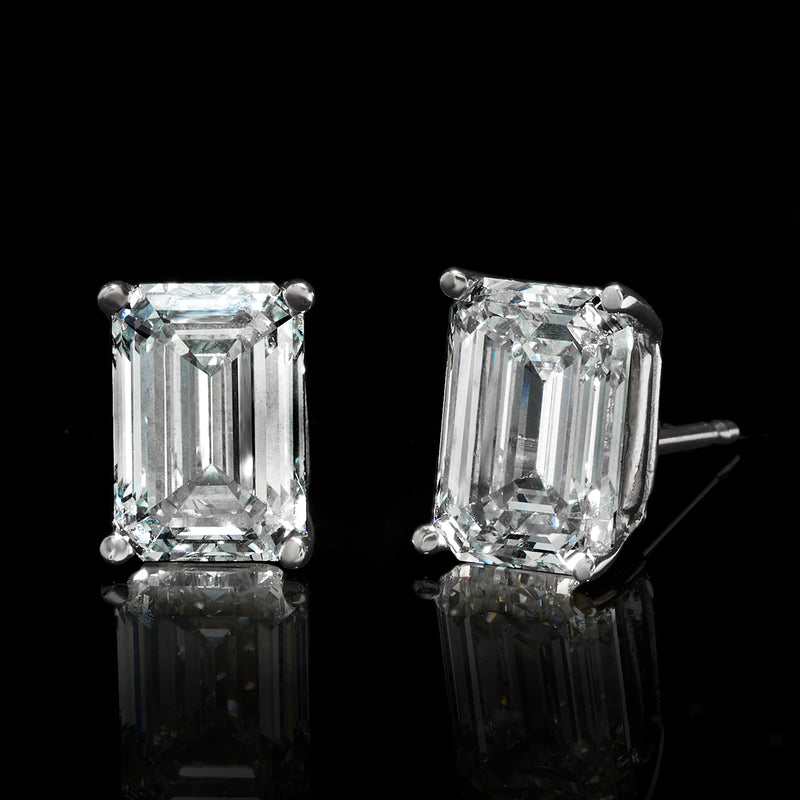 Emerald-cut diamond stud earrings with side view, four-prong rectangular stones in white gold