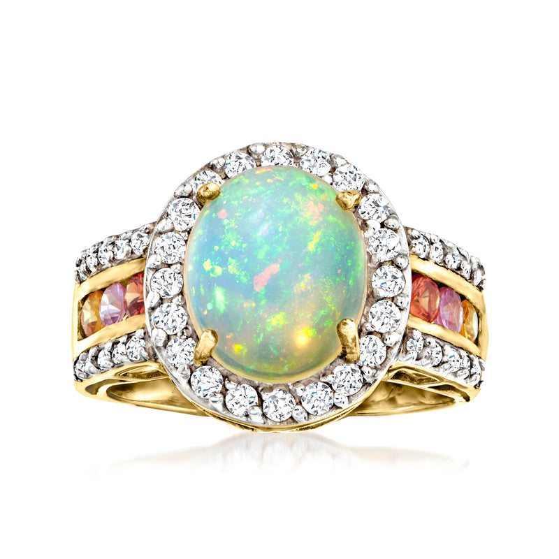 Gold opal ring with oval opal center, clear stone halo, and multicolored sapphire side accents