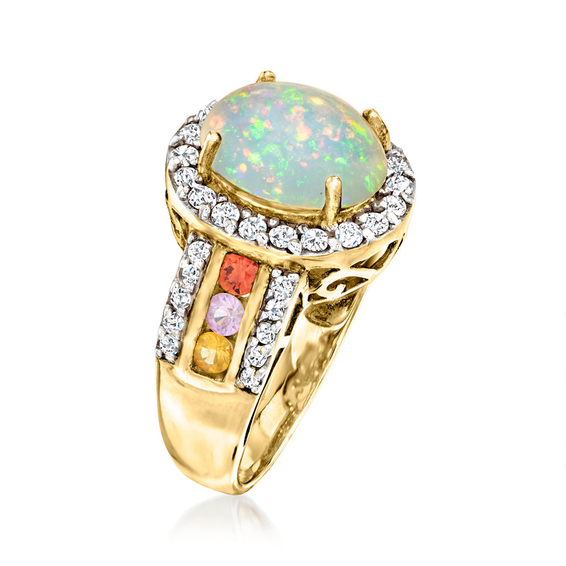 Gold opal ring angled view: oval opal with halo of clear stones, square multicolored accents