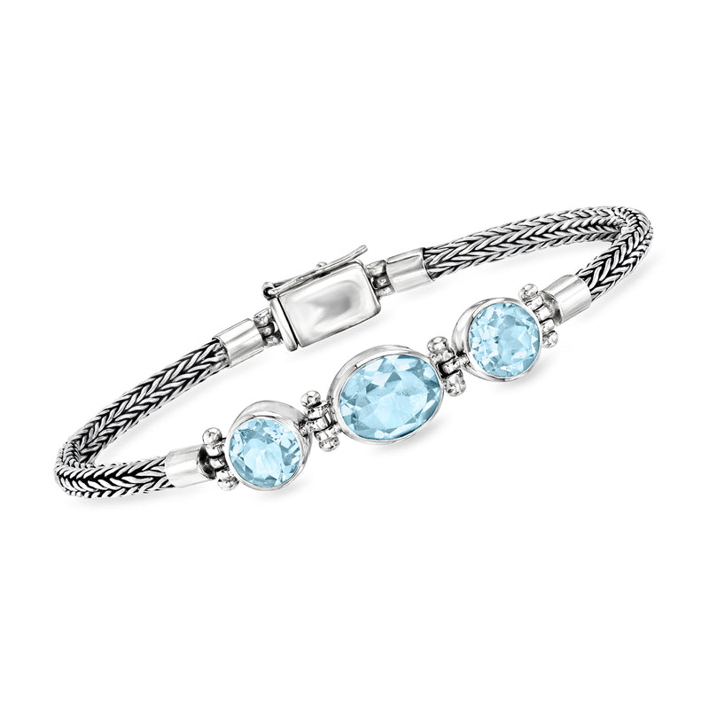 Bali-style sterling silver bracelet with braided design and four round sky-blue topaz stones
