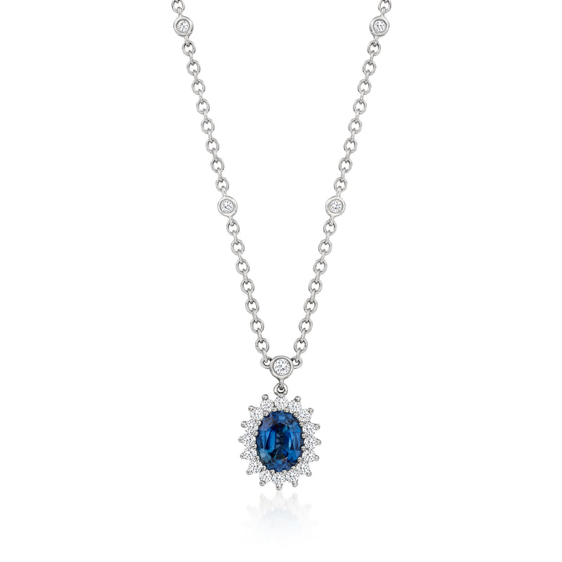Blue sapphire pendant necklace with diamond halo on a silver-tone chain