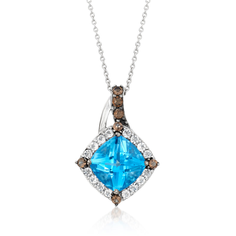Blue gemstone pendant necklace with halo of clear stones and small dark side accents