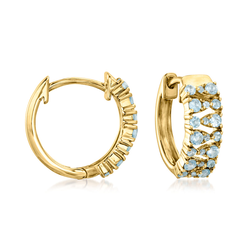 14kt yellow gold huggie hoop earrings with light blue topaz stones, hinged backs