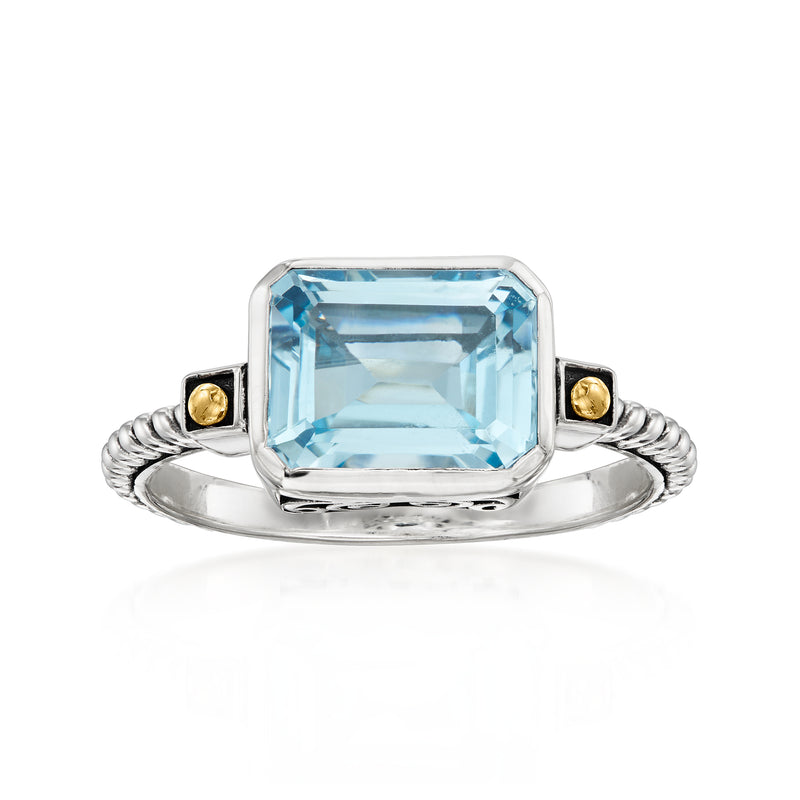 Sterling silver twisted ring with rectangular sky blue topaz and yellow gold side studs