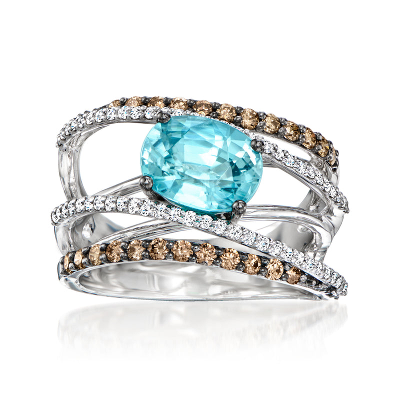 Oval blue topaz center ring with diamond rows and brown-and-clear accents in split band